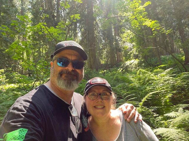 Gail and tim, owners of Extreme3 Fifteen, in the forest